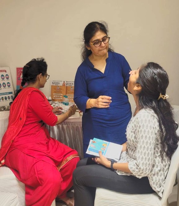 Dr. Karuna Prasad screening a patient at a community dental camp